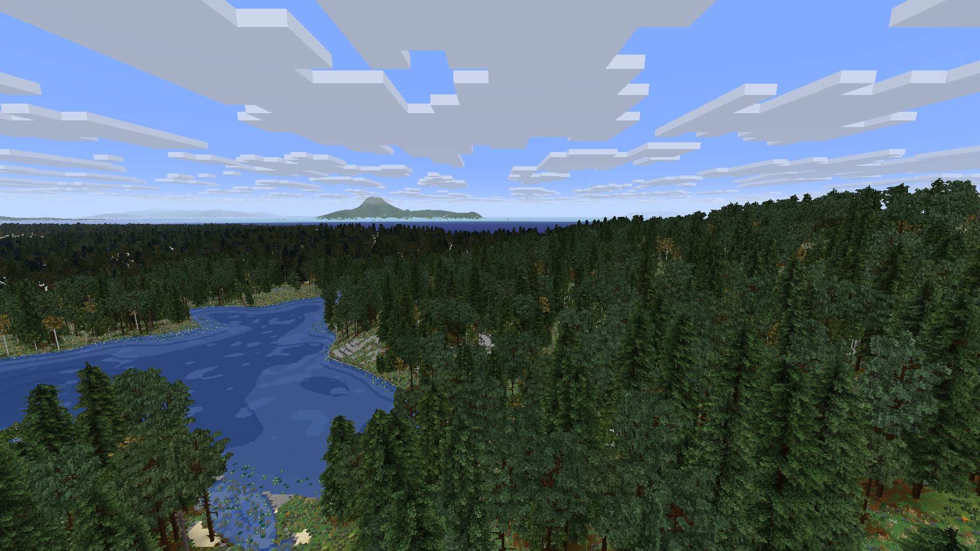 A forest and a lake below, an island on the horizon